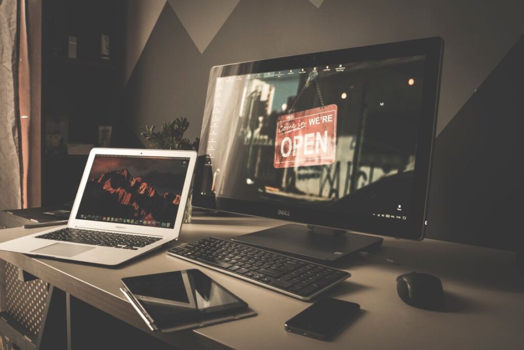 Stock photograph of a digital workspace with laptop and monitor